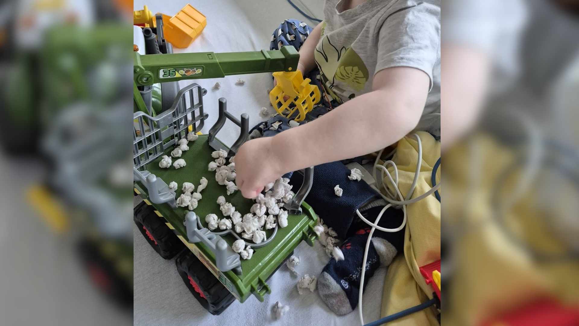 Ein Kind, das mit einem Spielzeugtraktor spielt
