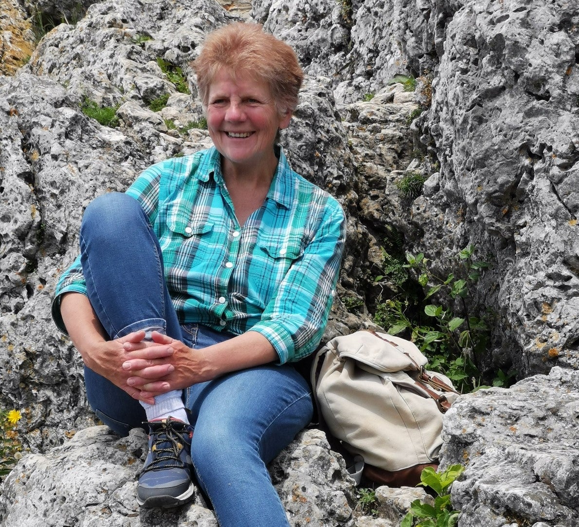 Eine Frau sitzt auf einem Felsen