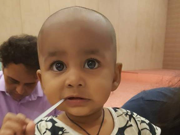 Ein Baby mit einem Wattestäbchen im Mund