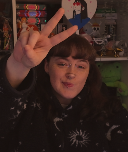 A woman holding up a peace sign