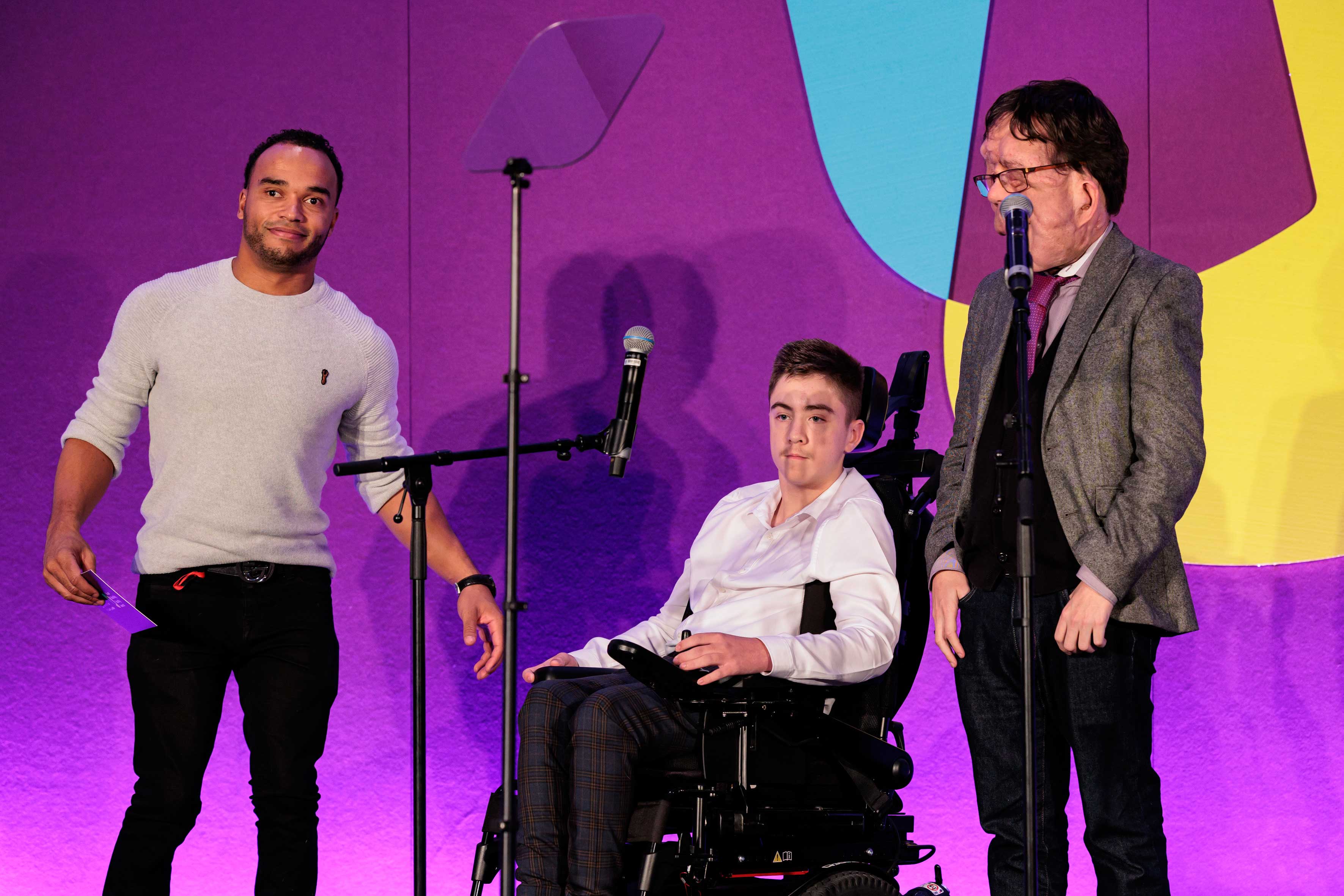 A group of people standing next to microphones