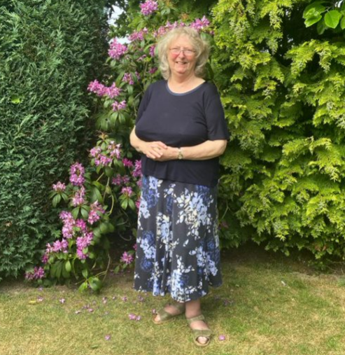 Gillian in her garden smiling