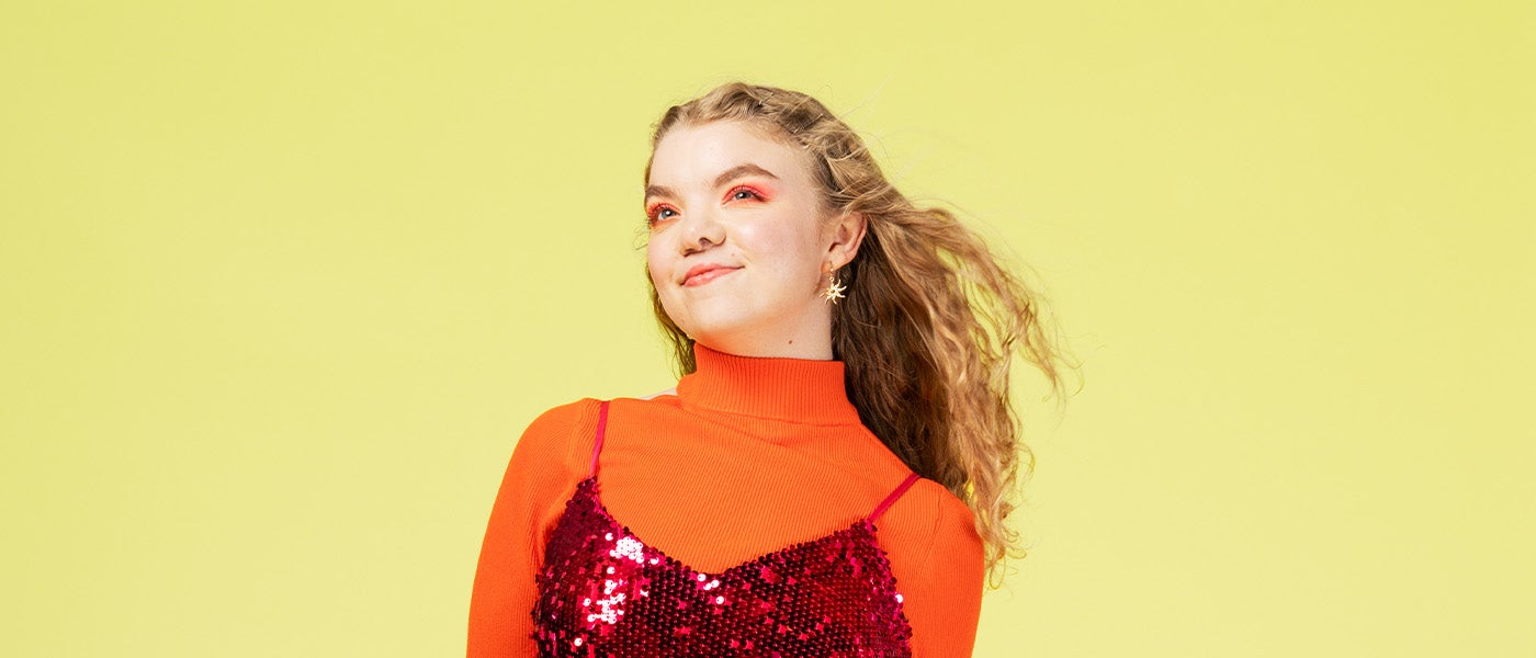 A woman with long hair wearing red and pink makeup