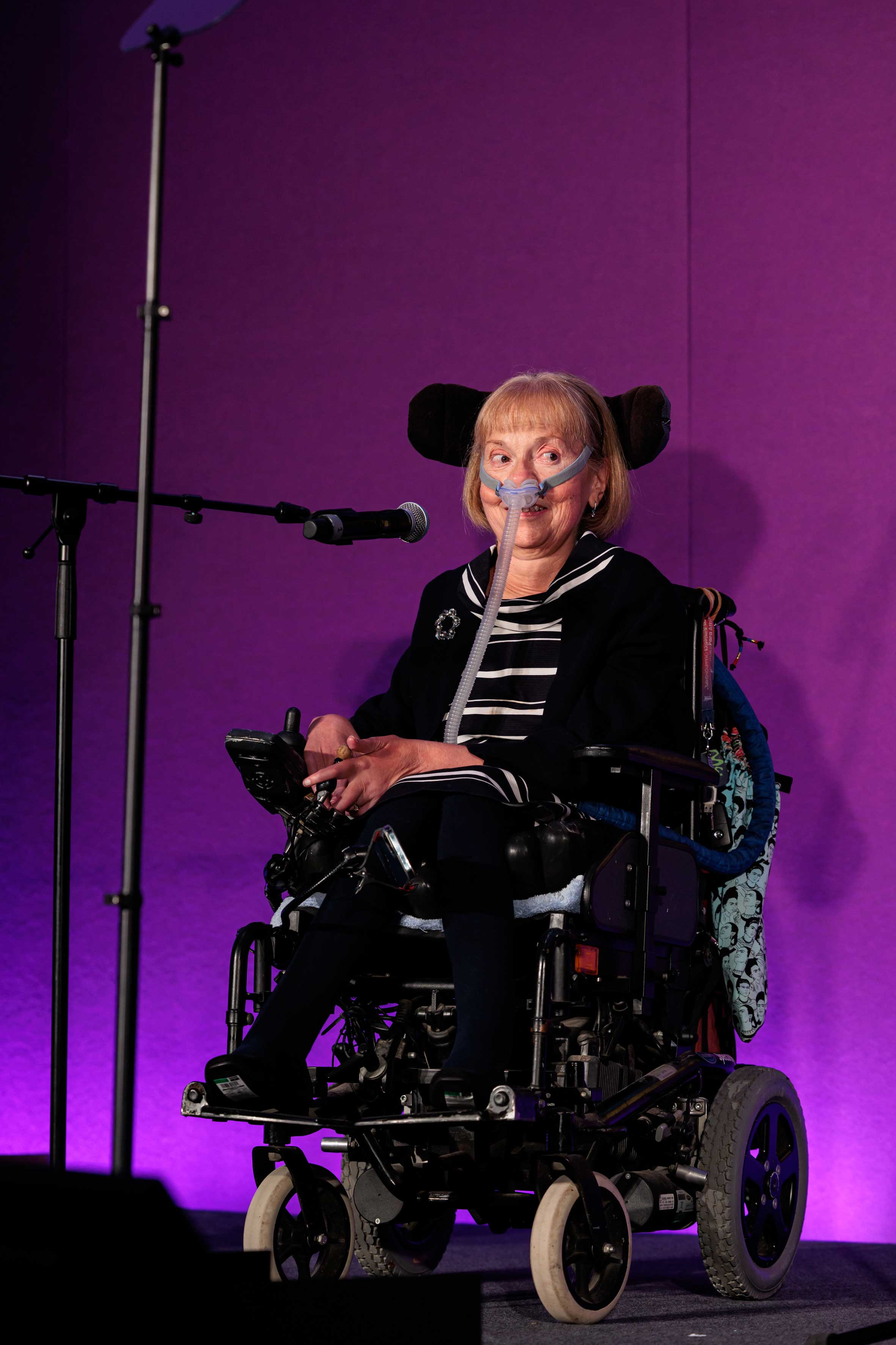 A woman in a wheelchair with a oxygen mask