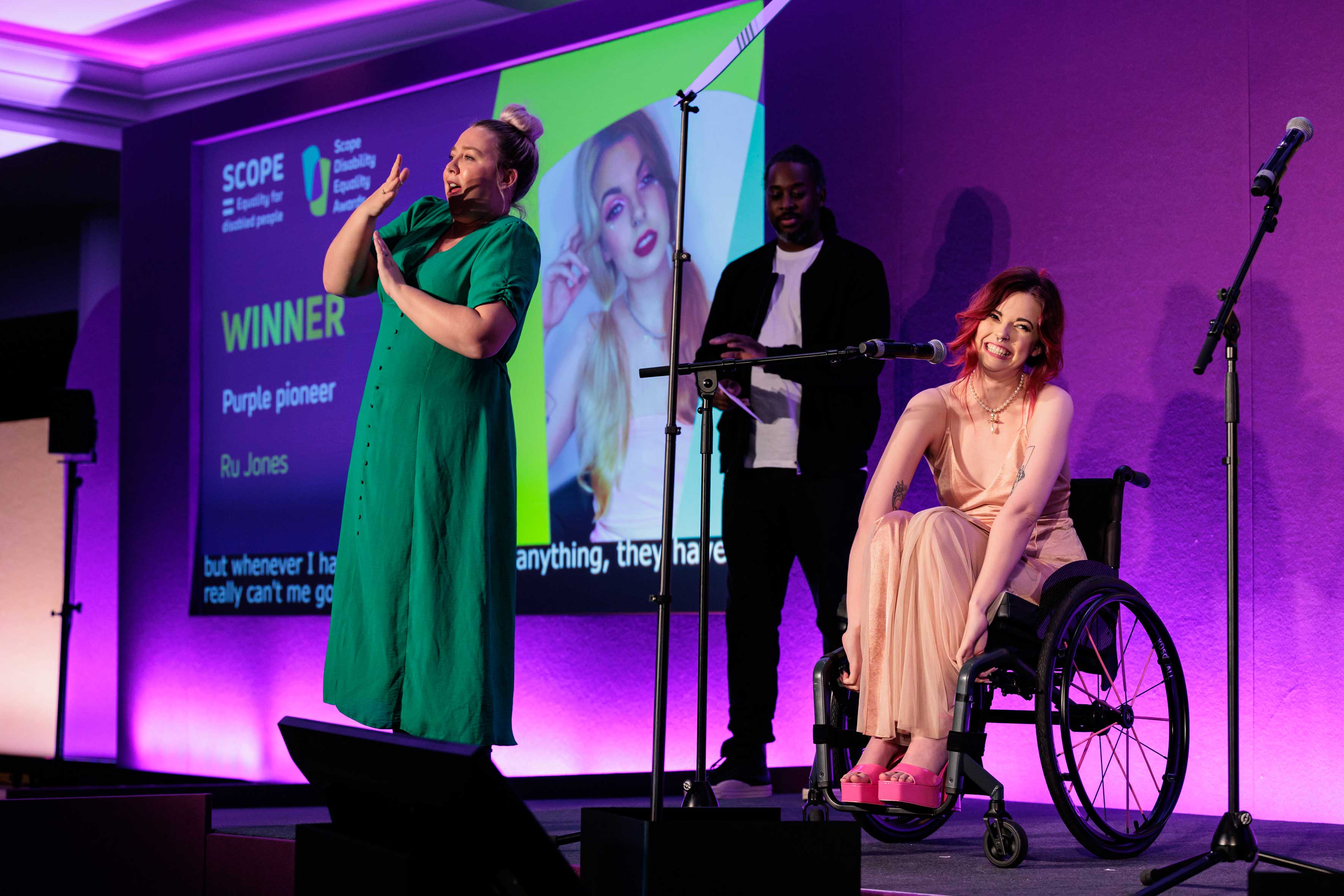 A woman in a wheelchair and another in a green dress