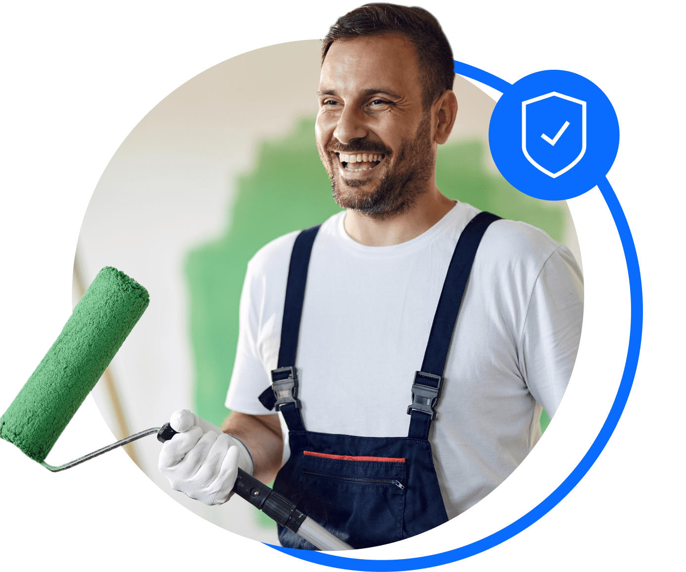 A painter in blue overalls holds a roller with green paint. He's smiling after sorting his trades insurance.