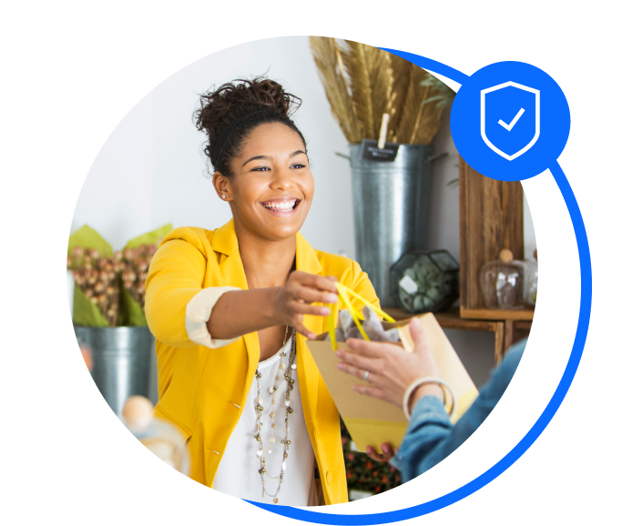 Giftshop owner handing over an item to customer