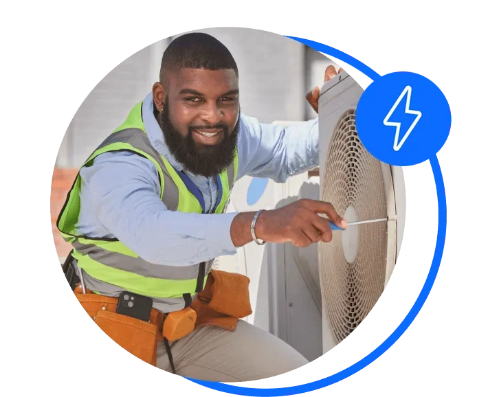 Handyman fixing a fan that runs on business electricity