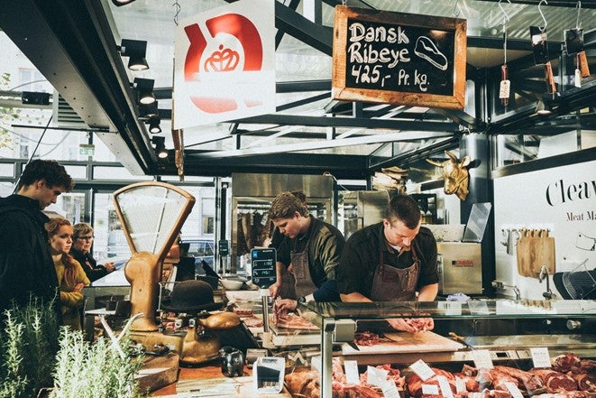 A busy butchers counter in Bristol advertising rib eye steaks