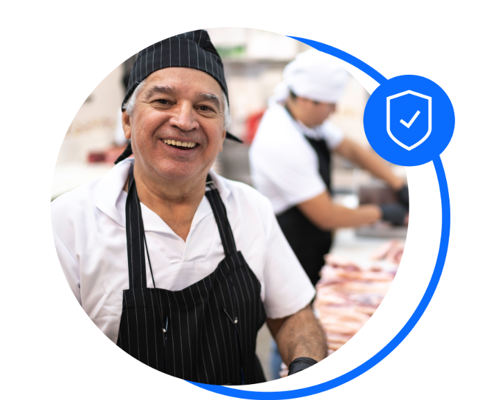 Male butcher working behind a meat counter