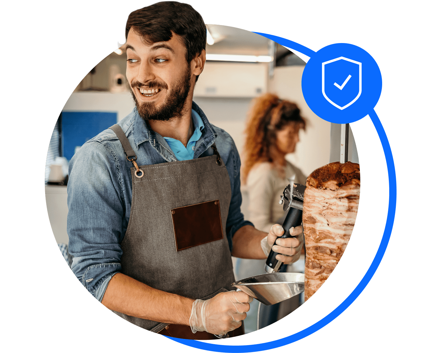 A takeaway owner shaves meat from a chicken kebab on a skewer. He's sorted his takeaway insurance with Bionic.