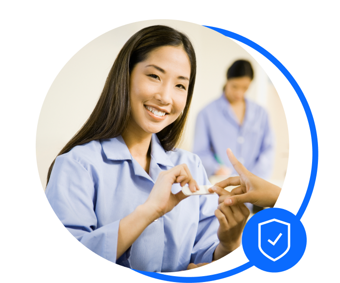 Nail technician working at a table with a client