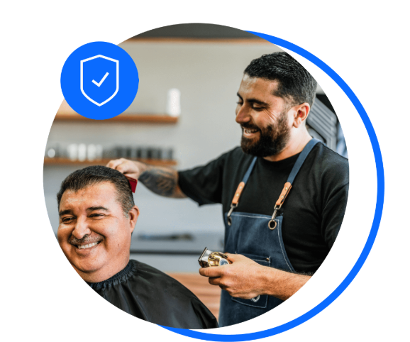 Barber clipping customer's hair