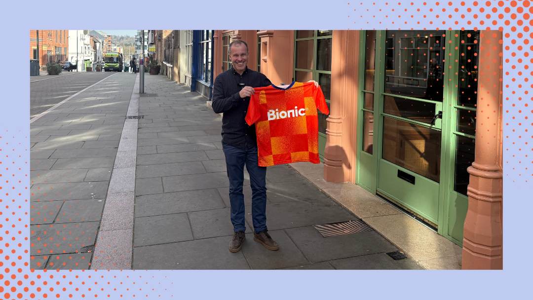 Dan Lindsay stands outside his Taquero restaurant holding a Bionic football shirt after winning his insurance free for a year.