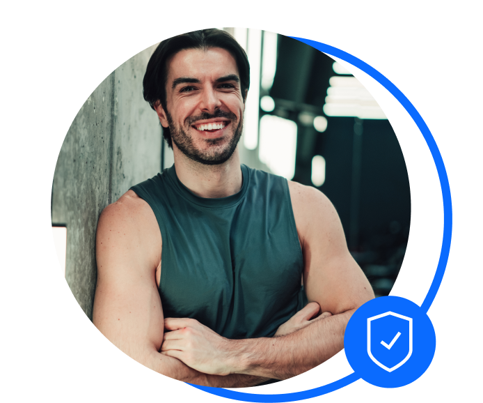 male gym owner stood against wall with crossed arms