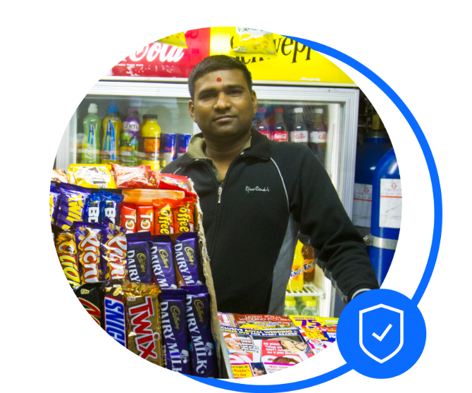 Newsagent stood behind counter