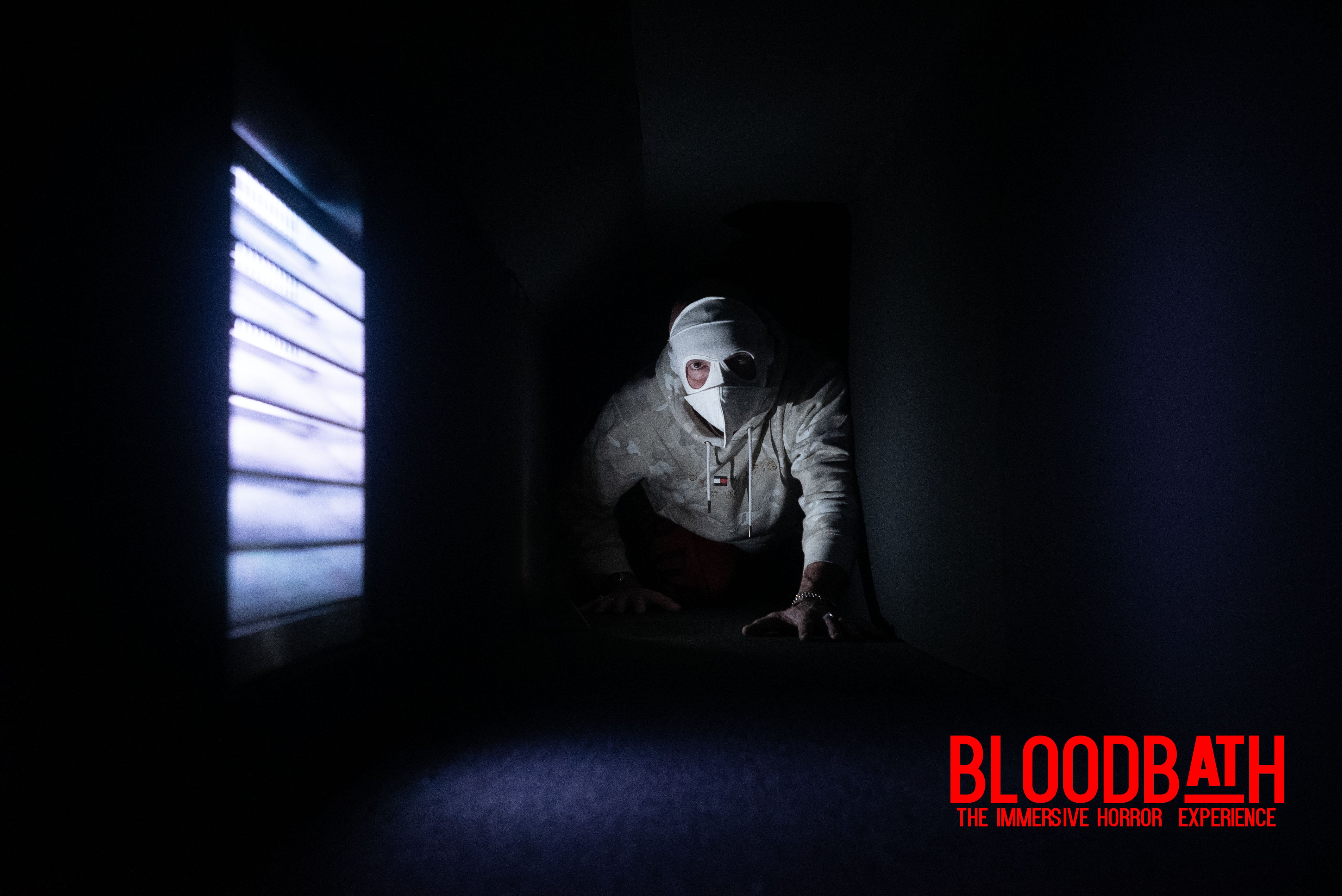 A man crawls through a dark tunnel 