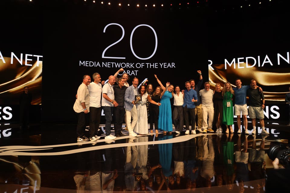 A group of people on staging celebrating winning Media Network of the year at Cannes Lions