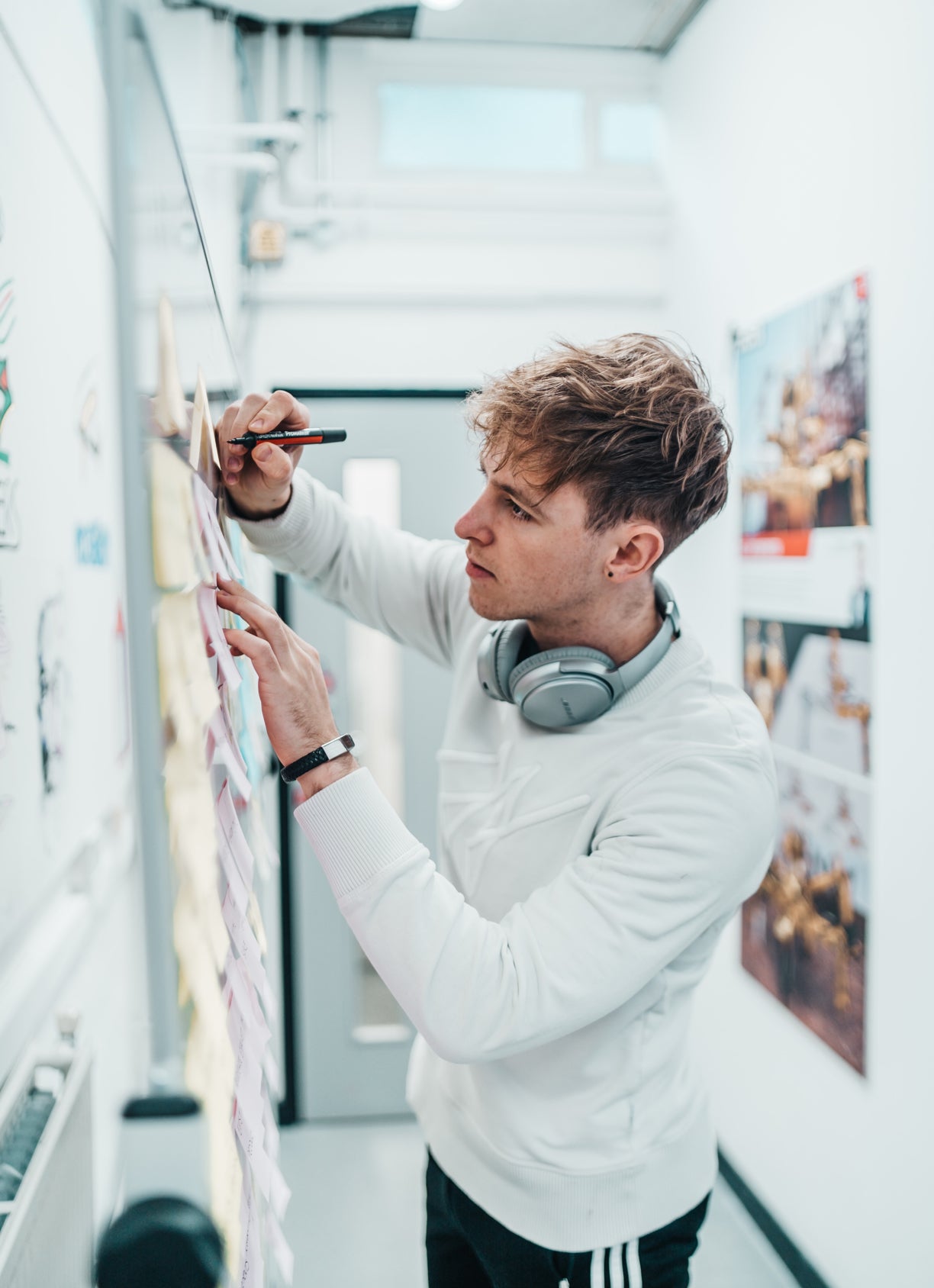 A student writing on the wall at Oxford Brookes University