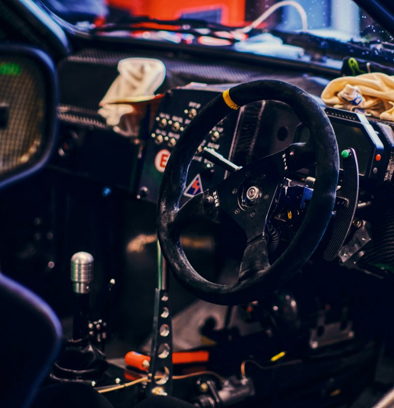 Inside of a rally car including gear stick and steering wheel