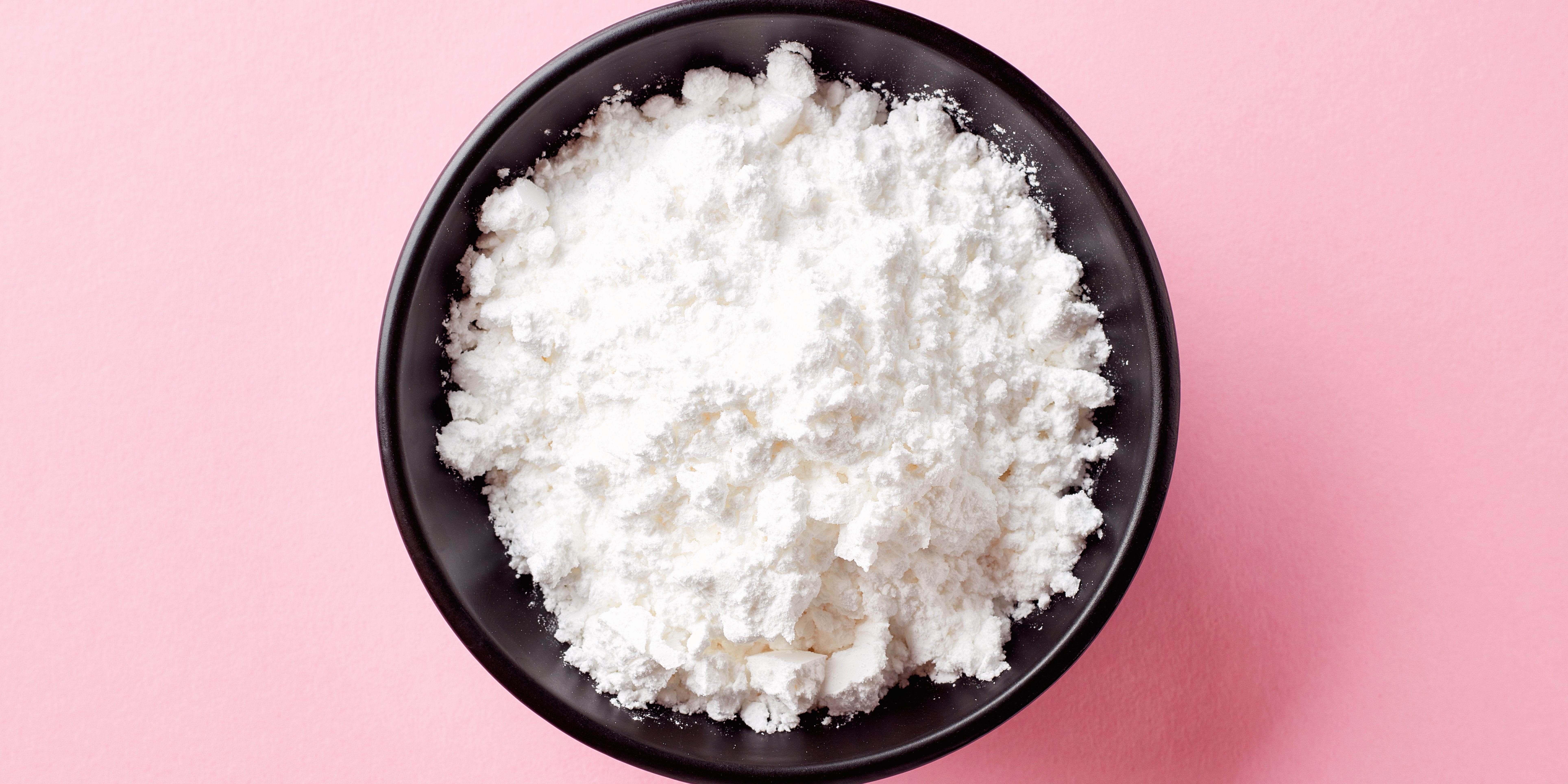 black bowl filled with icing sugar