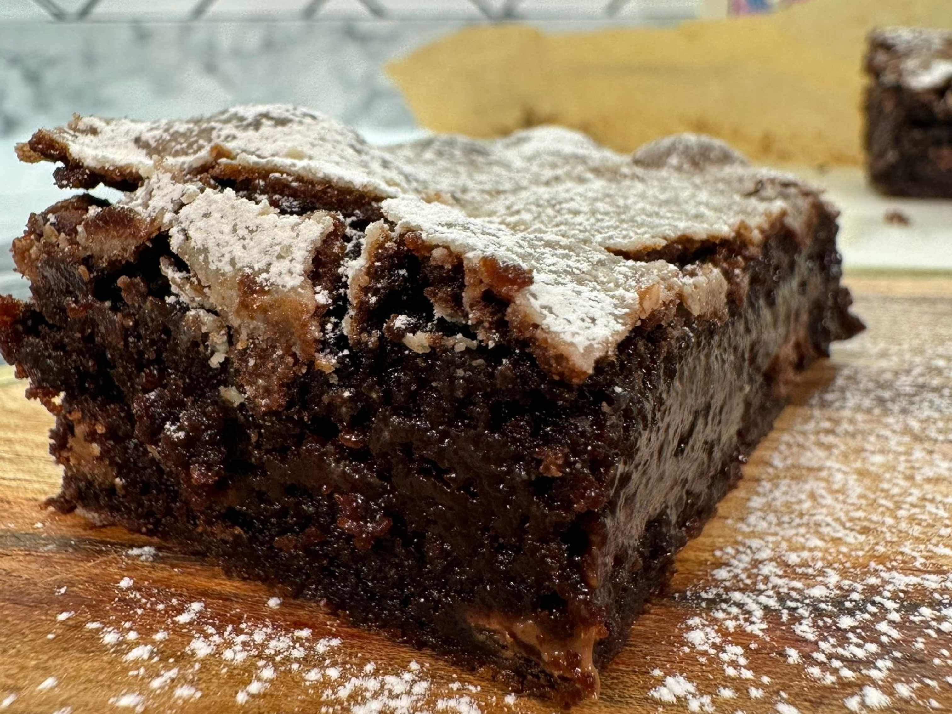 Close up shot of Mary Berry's brownie dusted with icing sugar
