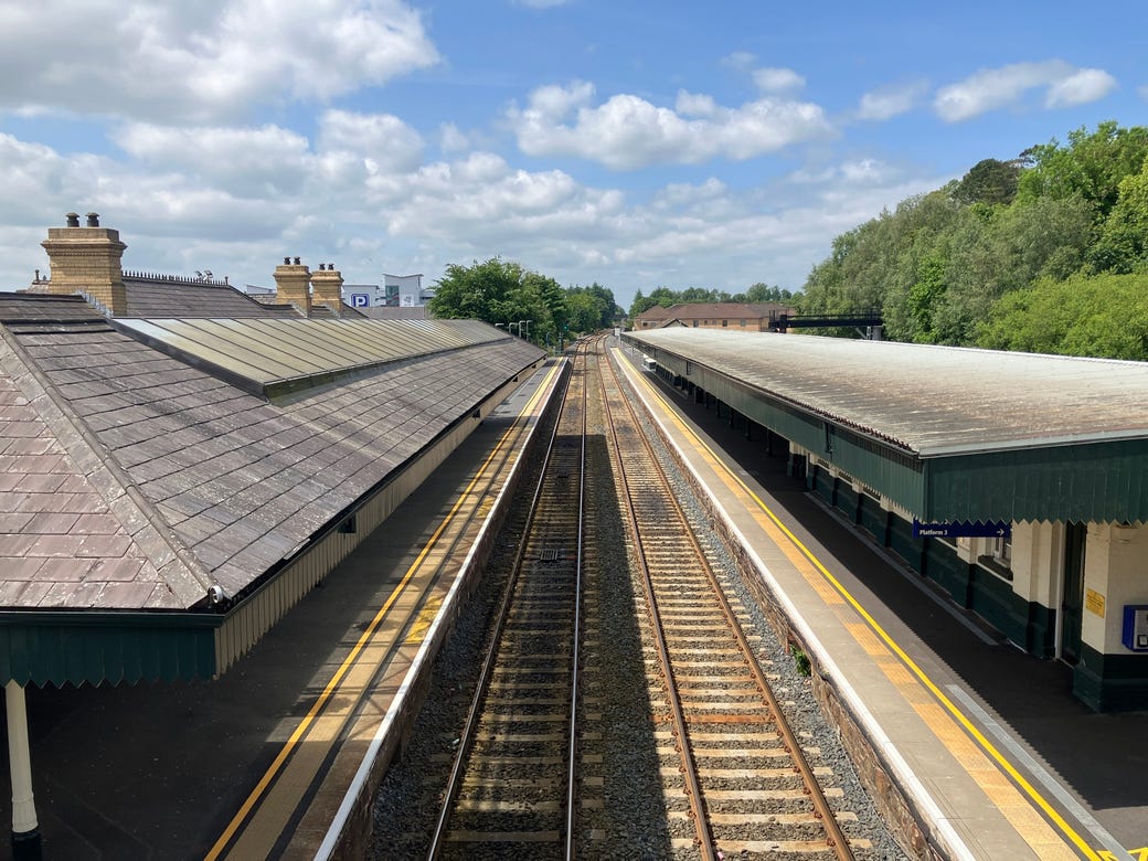 An empty Lisburn station, seen from above. The station, part of the Translink network has two train tracks running through the middle and slate roofs. 
Picture credit: Alexandra Taylor, used with permission.