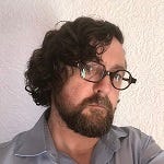 Allan O'Hare, white man with beard, glasses and wavy hair