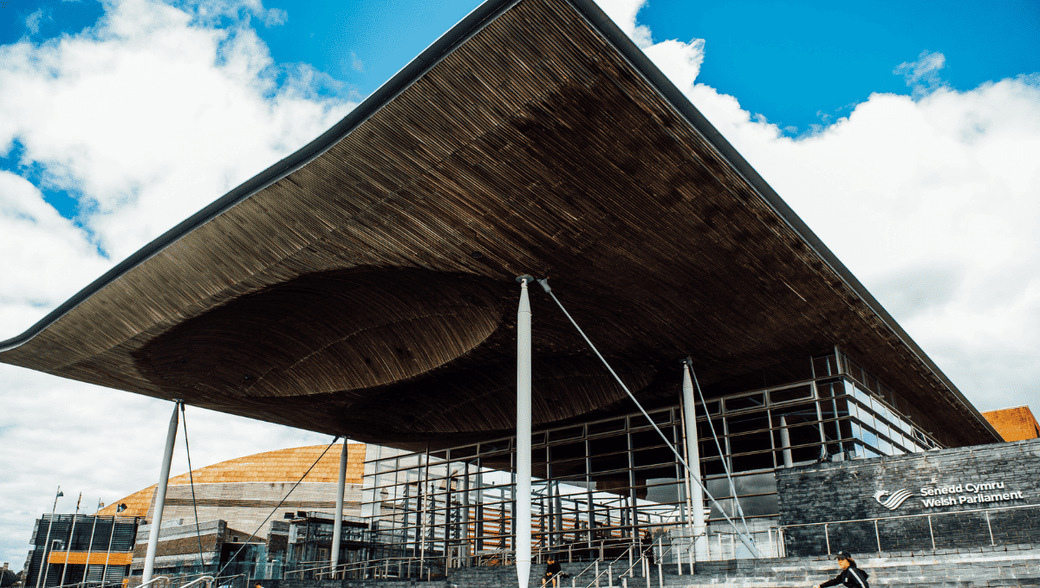 Welsh Parliament Senedd building exterior showing steps and overhanging roof. Copyright courtesy of Wales Senedd..