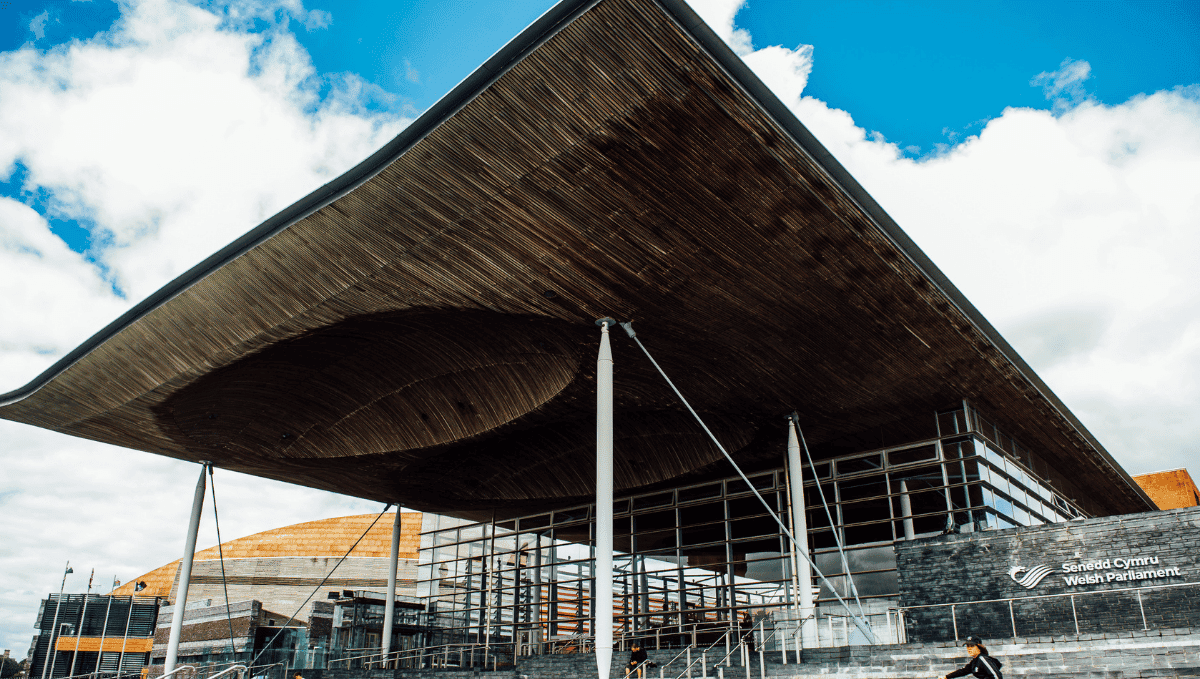 Welsh Parliament Senedd building exterior showing steps and overhanging roof. Copyright courtesy of Wales Senedd..