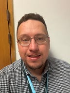 TSSA Rep, Daniel Lane a white man with glasses, brown hair and a check shirt. 