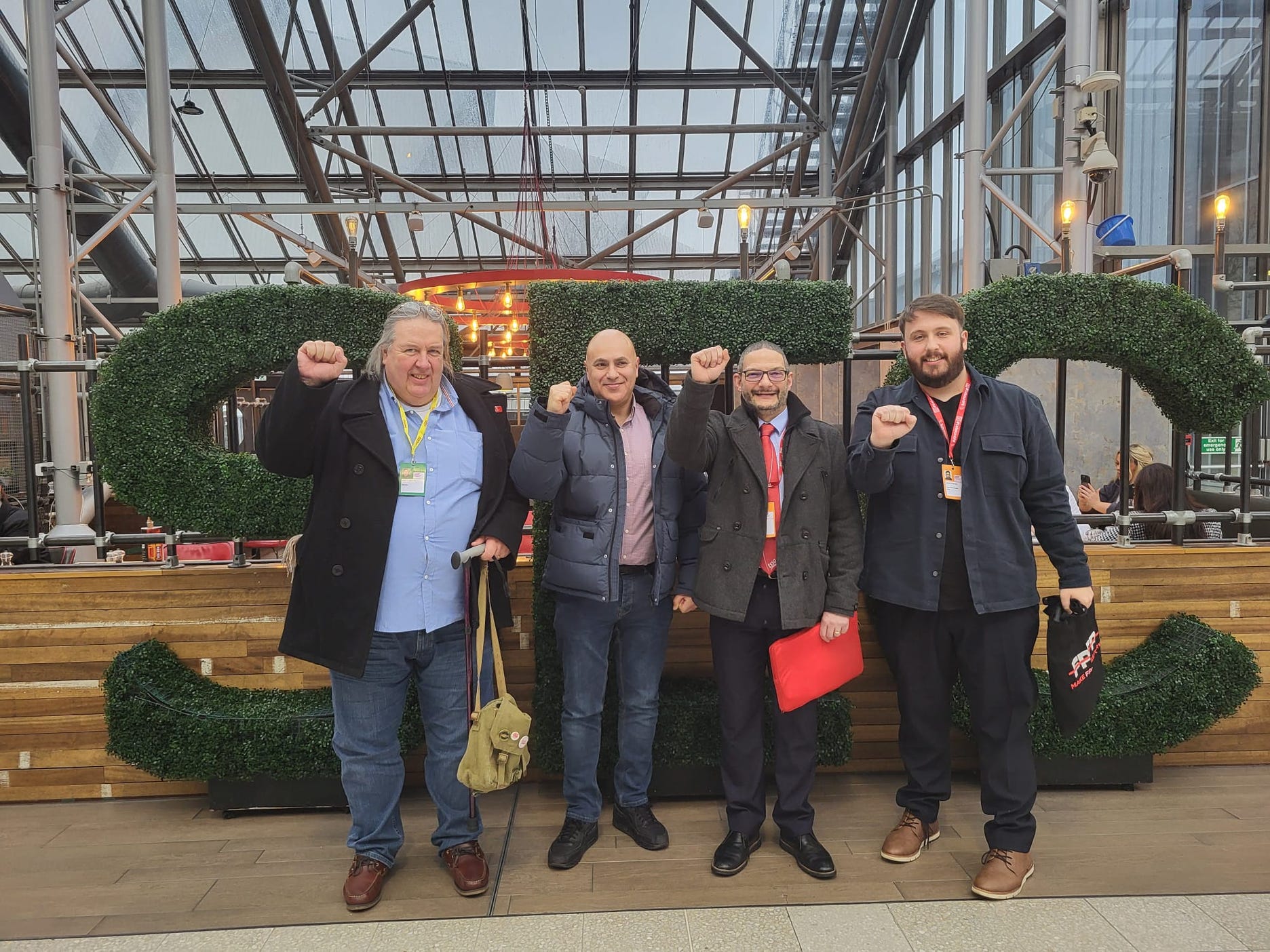 Four men stand outside the Scottish Event Campus during the 2024 Scottish Labour Party Conference 