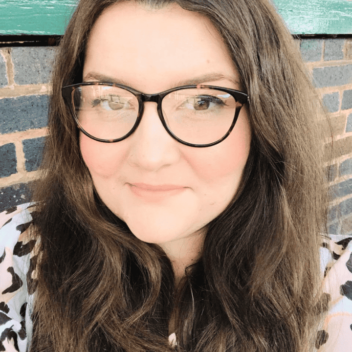 Gemma Southgate. She has brown hair and eyes and glasses. She is smiling.