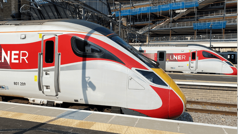 Two LNER trains at platforms in Kings Cross station