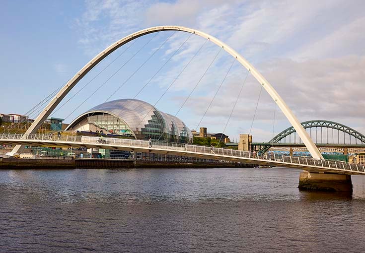 A bridge over water with a curved arch