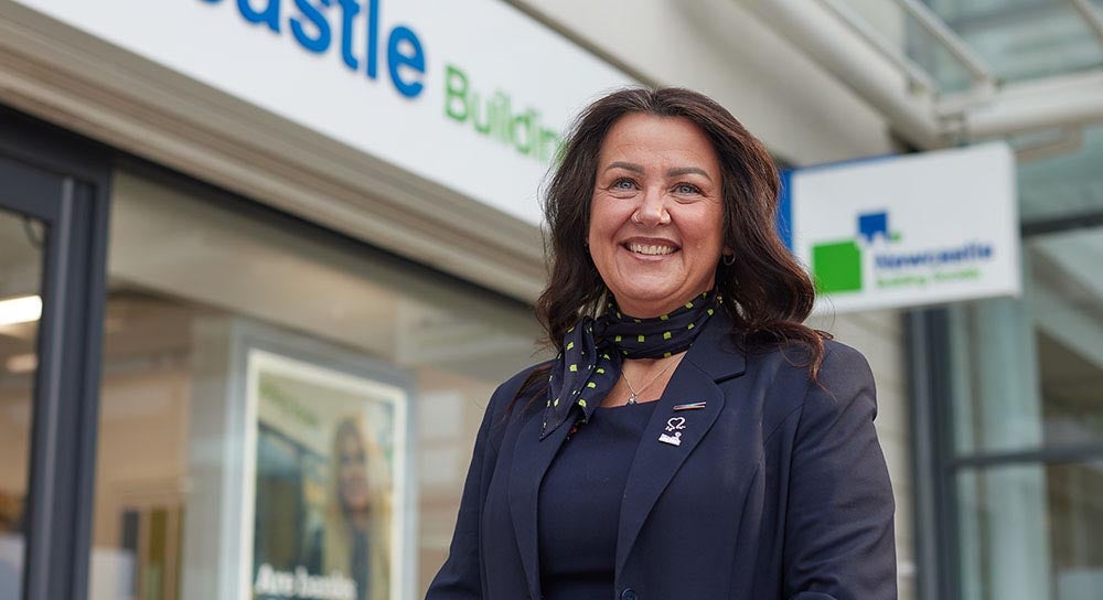 Branch manager smiling outside of West Denton branch.