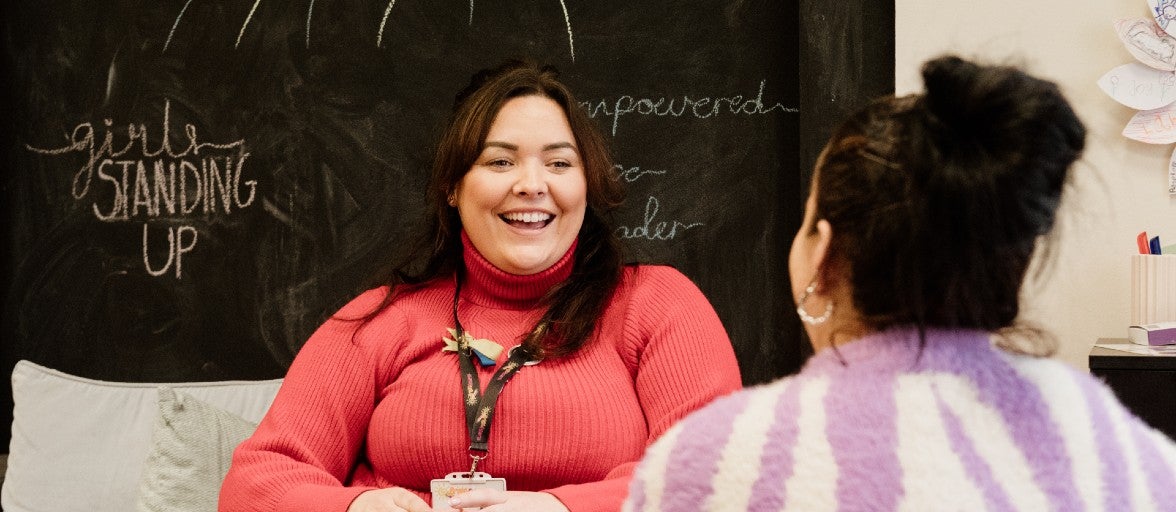 Two ladies sat chatting with each other.