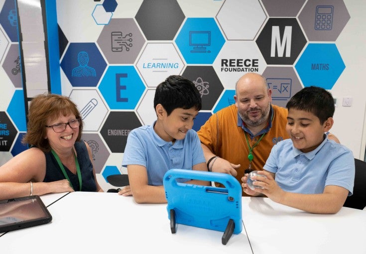 Two of our IT colleagues volunteering at a Newcastle United Foundation STEM session for schoolchildren.