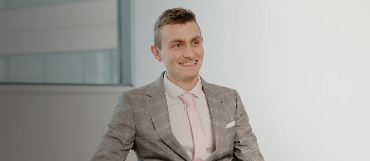 Newcastle Financial Adviser, Jonathan Cox, sat in an office smiling. 