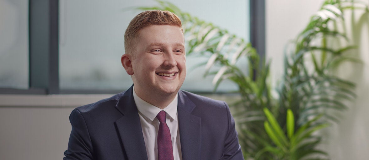 A man in a suit smiling