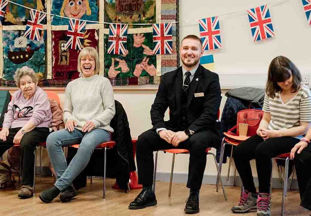 Branch staff and members smiling at a disability forum, community event.