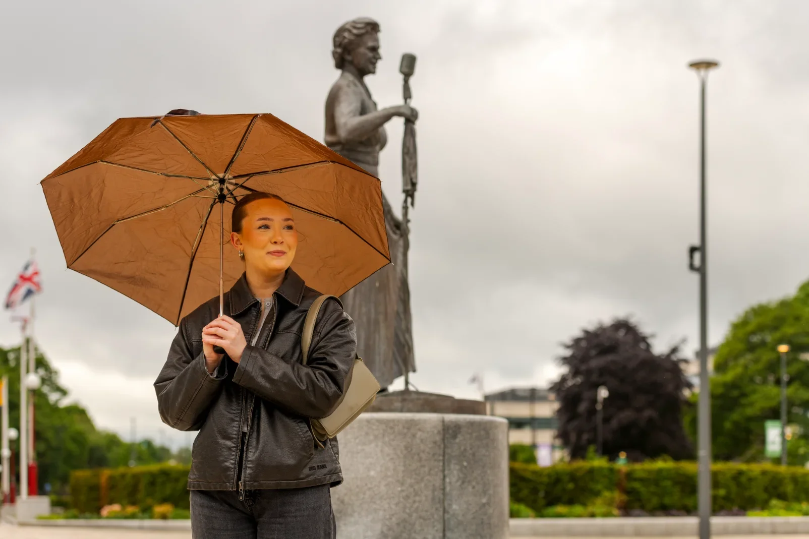 A woman holding an umbrella in Rochdale.