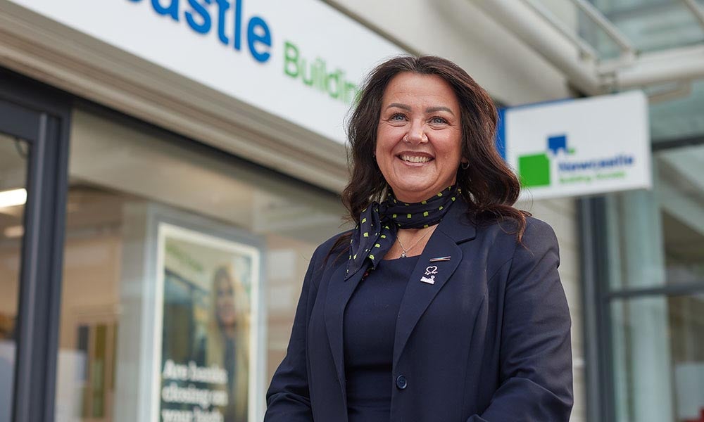 West Denton's Branch Manager, Michelle. Stood in front of the branch smiling. 