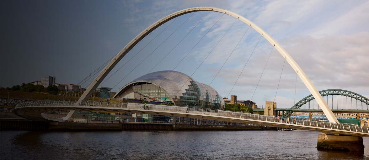 A bridge over water with a curved arch