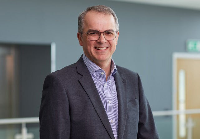 Andrew Haigh stood in head office smiling.