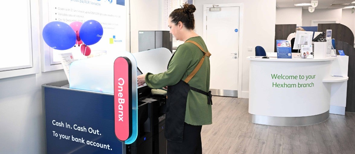 A lady using the OneBanx kiosk in Newcastle Building Society's Hexham branch.