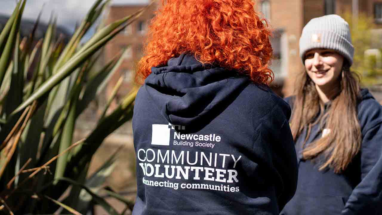 A person with red hair wearing a hoodie