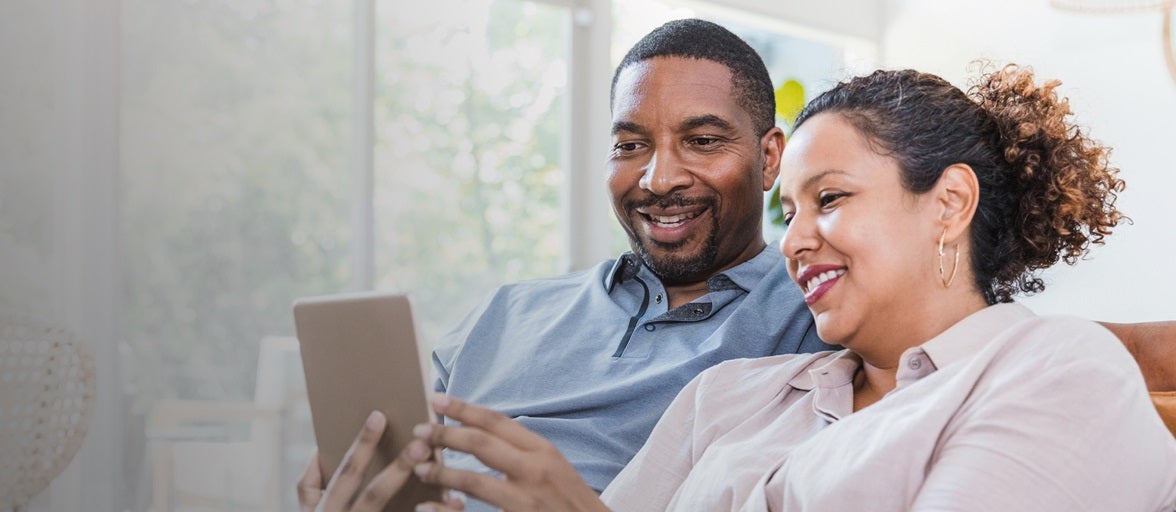 A couple checks on their tablet.