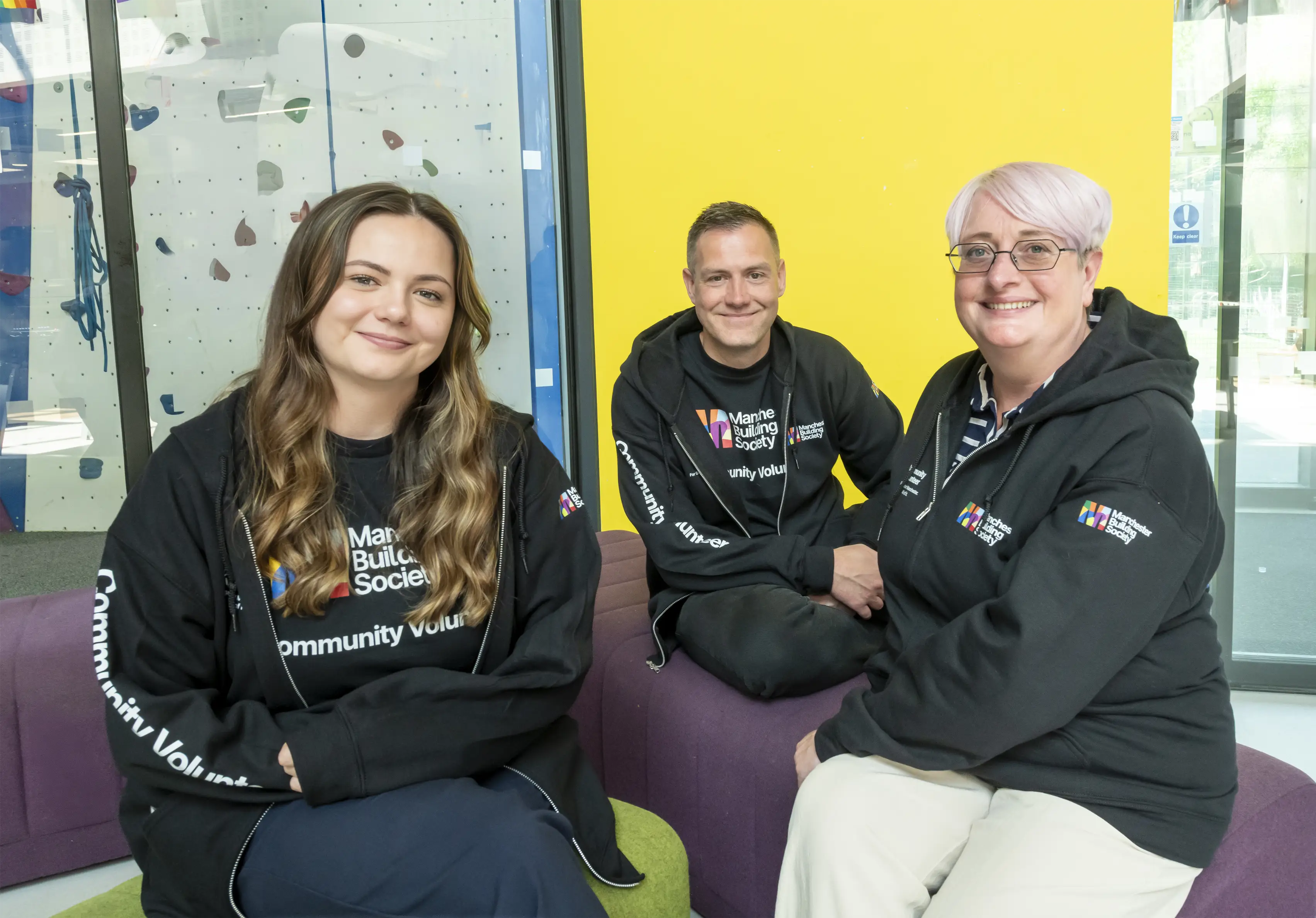 Three Manchester Building Society colleagues smiling 