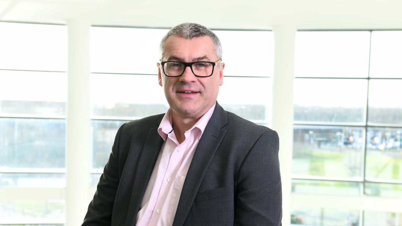 Iain Lightfoot, Managing Director of Newcastle Financial Advisers stood inside head office.
